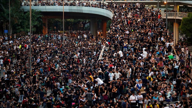 Protesters block the main street to the financial Central district, outside the government headquarters in Hong Kong 