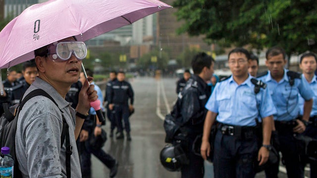 A protester blocks the entrance of Hong Kong's Chief Executive Leung Chun-ying's office along with other protesters in Hong Kong 