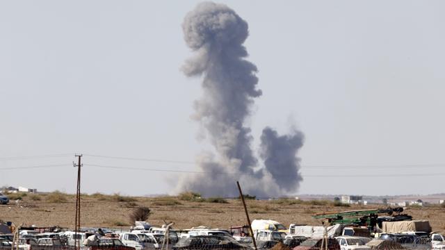 Smoke rises from the Syrian town of Kobani after a war plane carried out an airstrike 