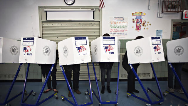 Voters fill in their ballots at a polling station in the Upper East Side of New York November 4, 2014. American voters will decide which party controls the U.S. Senate in Tuesday's elections, and at least 10 competitive races are still considered too clos 