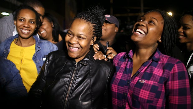 Family members surround Keisha Gaither, second from left, mother of kidnapping victim Carlesha Freeland-Gaither, as they celebrate following a news conference in Philadelphia Nov. 5, 2014, where investigators announced Freeland-Gaither was found safe outs 
