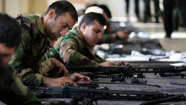 Kurdish peshmerga fighters train with weapons at their camp Nov. 3, 2014, in Erbil, the capital of the autonomous Kurdish region of northern Iraq. 