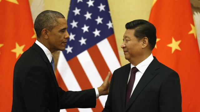 President Obama pats Chinese President Xi Jinping on the shoulder at the end of their news conference in the Great Hall of the People in Beijing on  November 12, 2014 