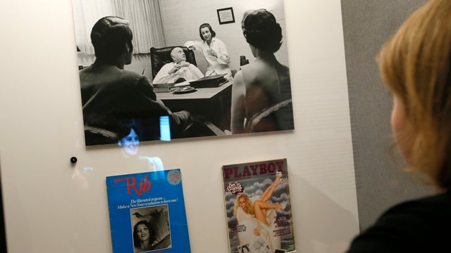 A member of the media looks at items on display at the Wellcome collection's Institute of Sexology 'Undress Your Mind' exhibition in London 