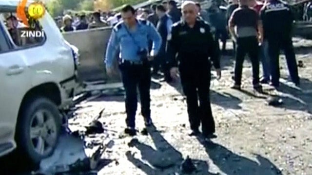 ​Iraqi Kurdish officials in the city of Erbil inspect the damage after a suicide bomber blew up a vehicle in the center of the city 