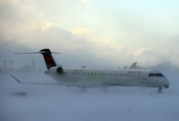A lake-effect snowstorm with freezing temperatures affected travel, like this plane that negotiated its way through the snow at Buffalo Greater International Airport, in Buffalo, N.Y., Nov. 18, 2014. 