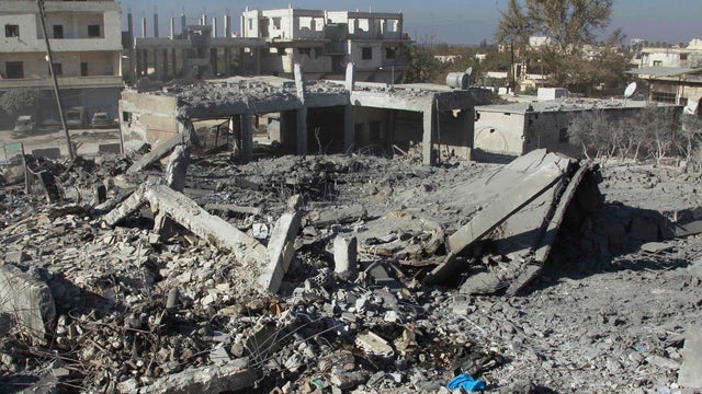 Collapsed buildings are viewed after a round of U.S.-led air strikes on Harem city in Idlib countryside 