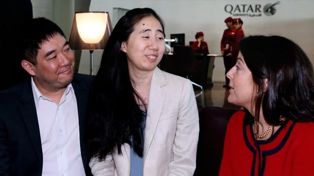 American couple Grace, center, and Matthew Huang, left, speak with U.S. Ambassador to Qatar Dana Shell Smith at the Hamad International Airport in Doha, Qatar, Dec. 3, 2014. 