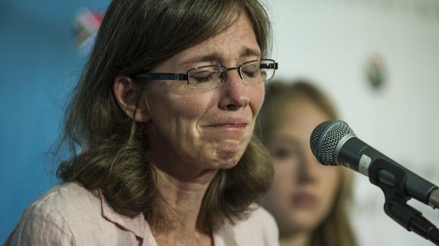 The widow of slain South African hostage Pierre Korkie, Yolanda Korkie, reacts during a press conference in Johannesburg 