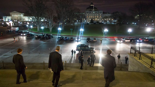 House members depart after narrowly passing huge spending bill to keep government running, on December 11, 2014 