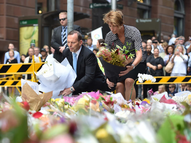 Australian Prime Minister Tony Abbott and his wife Margaret lay wreaths at a makeshift memorial near the site of fatal siege in the heart of Sydney's financial district, Dec. 16, 2014. 