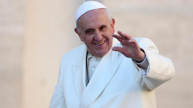 Pope Francis waves to the faithful as he arrives in St. Peter's Square for his weekly audience Dec. 17, 2014, in Vatican City. 