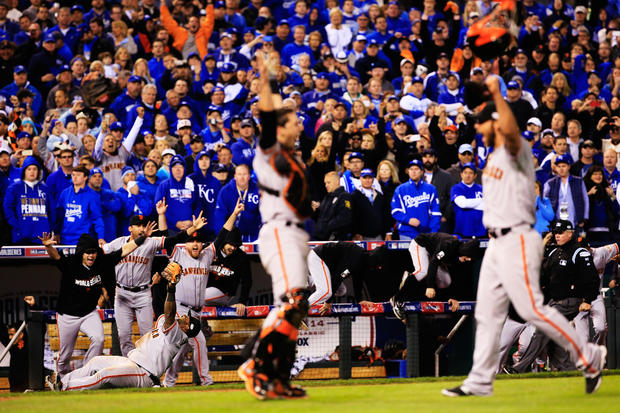 Buster Posey #28, Madison Bumgarner #40, Pablo Sandoval #48 and San Francisco Giants celebrate after beating Kansas City Royals to win Game Seven of 2014 World Series by score of 3-2 at Kauffman Stadium on Oct. 29, 2014 in Kansas City, Mo. 