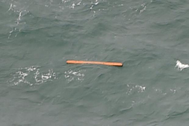 This aerial view taken from an Indonesian search and rescue aircraft over the Java Sea shows floating debris spotted in the same area as other items being investigated by Indonesian authorities as possible objects from missing AirAsia flight QZ8501 