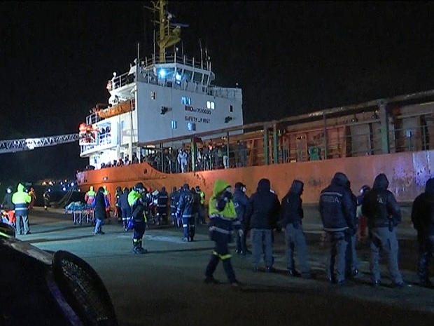 ​Italian police and other officials are seen at the dock in Gallipoli, Italy, where the freighter Blue Sky M was safely docked after being rescued at sea 
