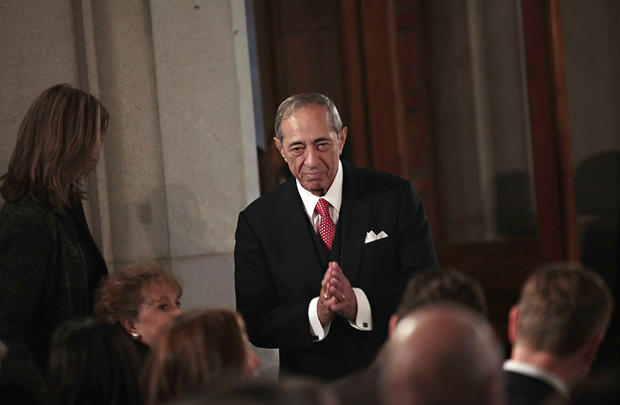 Former New York Governor Mario Cuomo reacts to applause at a swearing-in ceremony for his son 