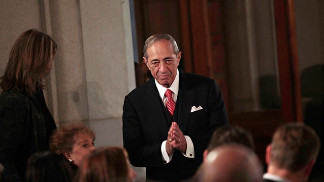 Former New York Governor Mario Cuomo reacts to applause at a swearing-in ceremony for his son 
