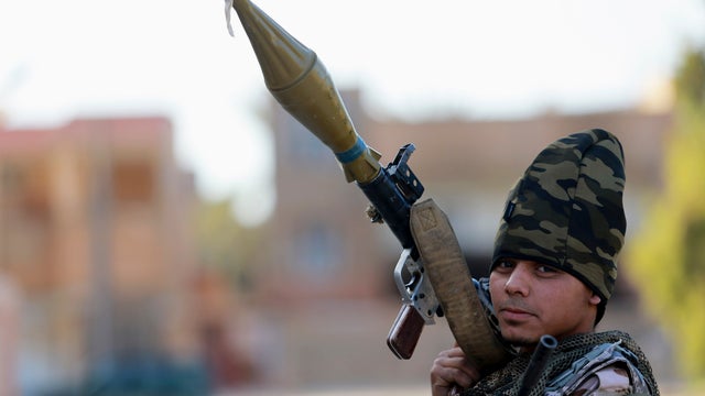 A pro-government Libyan militia member, who are backed by locals, holds a rocket-propelled grenade (RPG) during clashes in the streets with the Shura Council of Libyan Revolutionaries. December 28, 2014. 