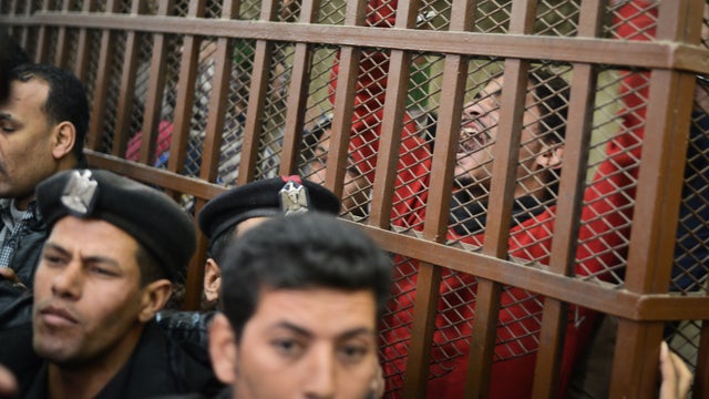 Defendants react behind the bars at a court in Cairo following the acquittal of 26 men accused of "debauchery" after they were arrested in a night-time raid on a bathhouse  