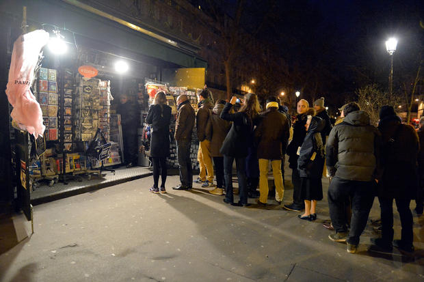 Customers wait in line at Pigalle newstand, where the new edition of Charlie Hebdo magazine was on sale 