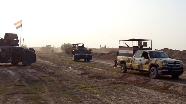 Iraqi security forces guard during the building of a new road between Diyala province and Samarra Dec. 21, 2014.  