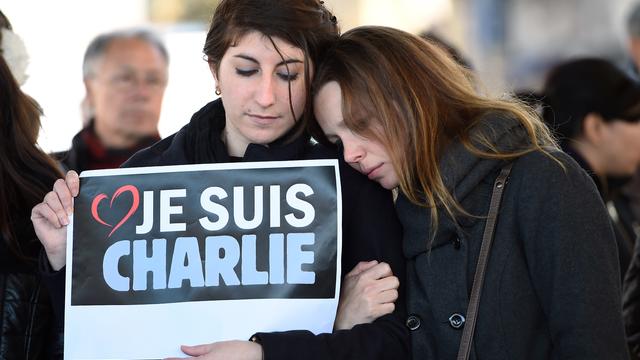People hold a sign reading ''I am Charlie'' after observing a minute of silence in the old Harbor in Marseille 