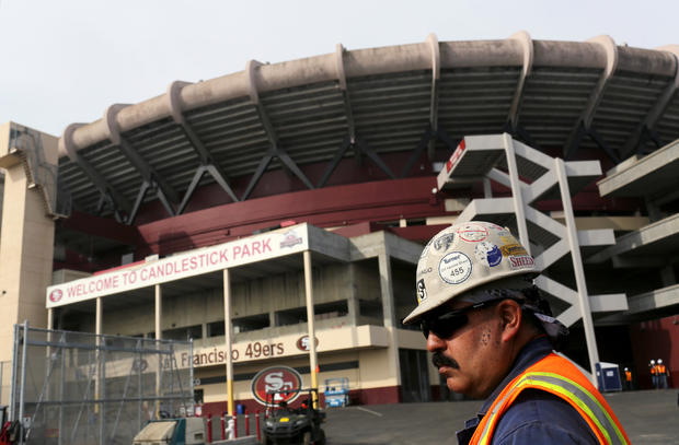A worker stands outside Candlestick Park in San Francisco, California, Feb. 4, 2015. 