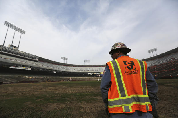 A worker stands on the field at Candlestick Park in San Francisco, California, Feb. 4, 2015. 