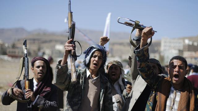 Followers of the Houthi movement shout slogans during a gathering to show support to the movement, outside the Presidential Palace in Sanaa 