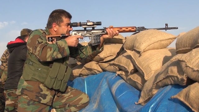 ​A Kurdish peshmerga fighter holds a position in northern Iraq's Sinjar province, where the militia has been fending off ISIS 