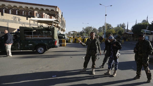 Police troopers stand guard at the entrance of the U.S. Embassy in Sanaa 