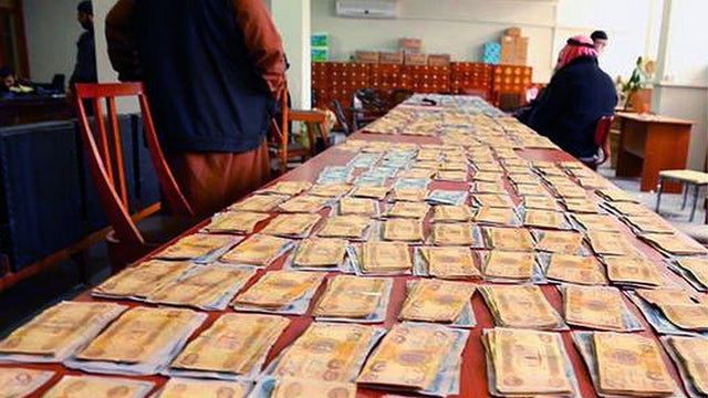 ​An unverified image posted to an ISIS-affiliated Twitter account on Feb. 22, 2015, purports to show stacks of Iraqi dinars designated by the group as Zakat, or alms, for poor residents  