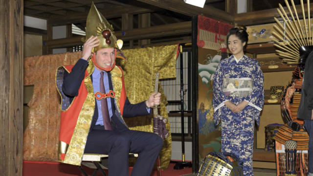 Britain's Prince William, the Duke of Cambridge, tries on a samurai costume as Japanese actress Mao Inoue looks on during his visit to a Taiga historical drama studio set at NHK (Japan Broadcasting Corporation) in Tokyo Feb. 28, 2015, in this photo releas 