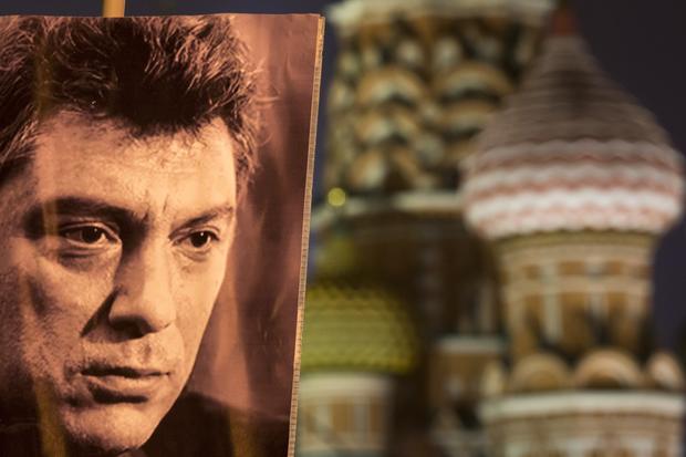 A portrait of Russian opposition leader Boris Nemtsov, and sharp critic of President Vladimir Putin, who was gunned down Feb. 27, 2015 near the Kremlin, seen at right with St. Basil's Cathedral in the background in Moscow 