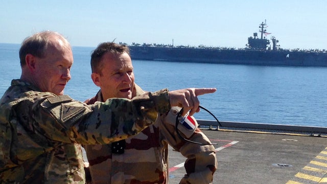 Gen. Martin Dempsey, chairman of the U.S. Joint Chiefs of Staff, left, confers with his French counterpart, Gen. Pierre de Villiers, aboard the French aircraft carrier Charles de Gaulle in the Persian Gulf 