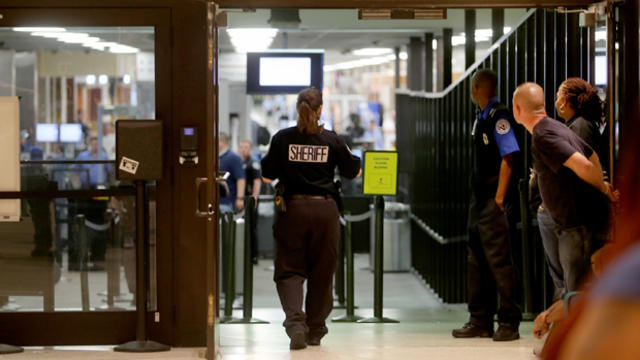 Police investigate on Concourse B of New Orleans Louis Armstrong International Airport after a machete-wielding man was shot by a TSA employee March 20, 2015. 