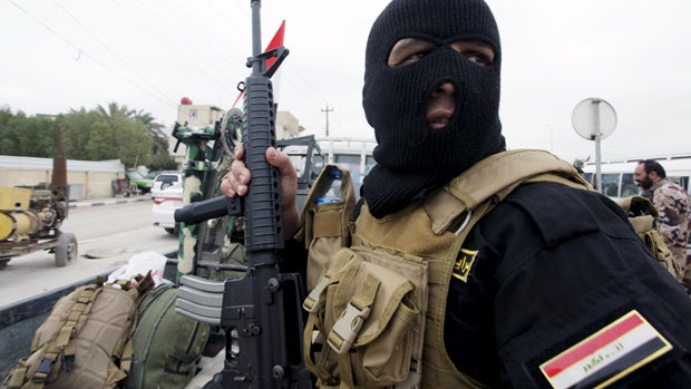 A Shi'ite fighter from Saraya al-Salam, who are loyal to radical cleric Muqtada al-Sadr, sits in the back of a vehicle as he leaves from the holy city of Najaf in a convoy of vehicles heading to the northern Iraqi city of Tikrit to continue the offensive  