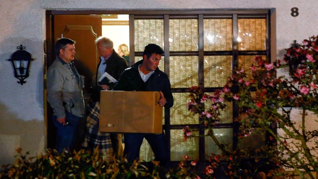 German police officers carry boxes out of a house belonging to the parents of crashed Germanwings Flight 9524 co-pilot Andreas Lubitz in Montabaur 