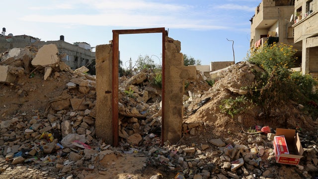 An empty door frame is seen standing amid the rubble of building destroyed during last summer's Israel-Hamas war east of Jebaliya 