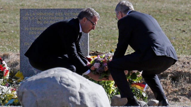 Lufthansa Chief Executive Carsten Spohr (L) and Germanwings Managing Director Thomas Winkelmann place flowers at the memorial for the victims of Germanwings Flight 9525 in the village of Le Vernet, near the crash site in French Alps 