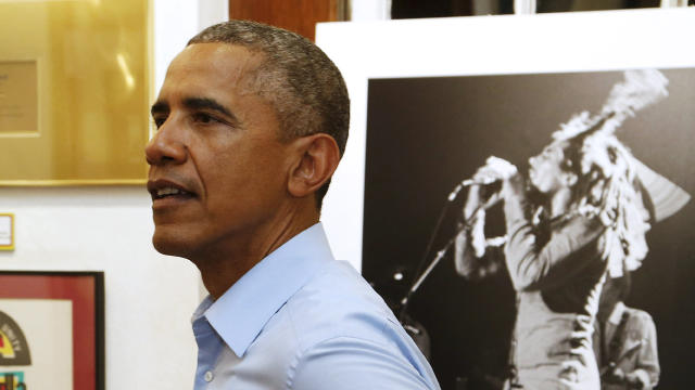 President Obama looks on as he gets a tour of the Bob Marley Museum in Kingston, Jamaica 