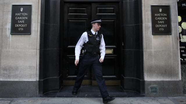 A police officer emerges from a Hatton Garden safe deposit center April 7, 2015, in London, England. 