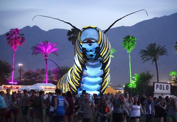A giant caterpillar moves through the crowd on the first day of the Coachella Music Festival in Indio, California, April 10, 2015. 