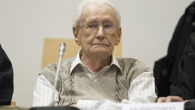 Oskar Groening, 93, arrives for the first day of his trial to face charges of being accomplice to the murder of 300,000 people at the Auschwitz concentration camp 