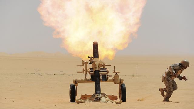 A Saudi soldier fires a mortar toward a Houthi rebel position in Yemen from the Saudi border 