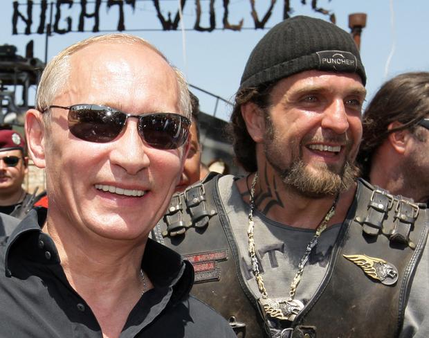 Vladimir Putin walks with Alexander Zaldostanov, nicknamed "the Surgeon", the leader of the group of Russian bikers called the Night Wolves, as they meet Russian and Ukrainian motorbikers at their camp near Sevastopol in then-Ukrainian Crimea 