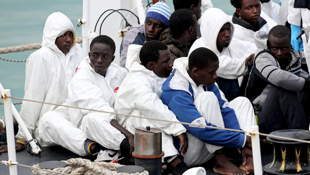 Migrants look on before arriving at the Sicilian harbor of Catania April 24, 2015. 