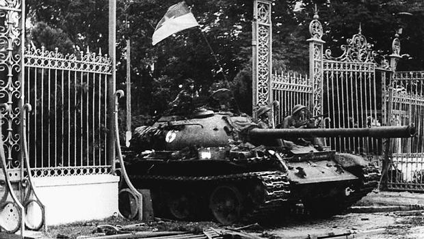 A North Vietnamese communist tank drives through the main gate of the presidential palace of the U.S.-backed South Vietnam regime as Saigon falls into the hands of communist troops April 30, 1975. 