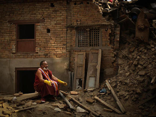 A Buddhist monk pauses during search efforts for earthquake victims in Sankhu, northeast of Kathmandu 
