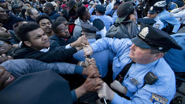 Protesters rush a police line after a rally at City Hall in Philadelphia April 30, 2015. 